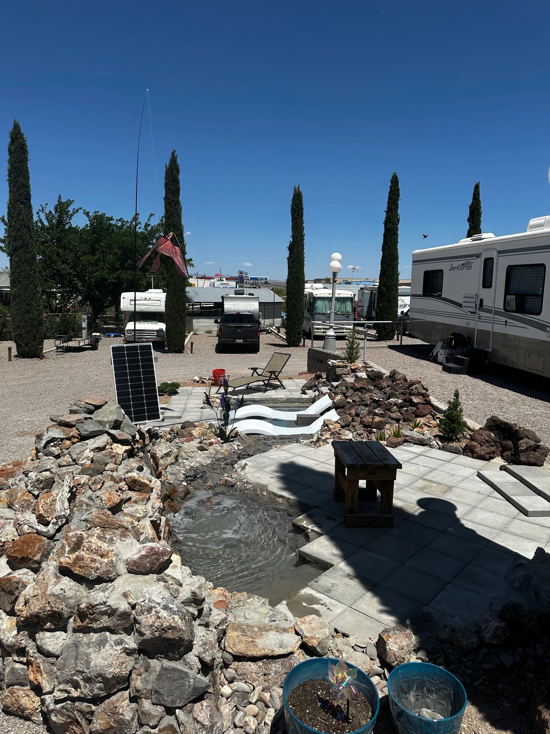 Rio Lago RV Park overview with water feature and lounge area